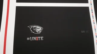 Press proof sheet with color registration bars showing the Beavers logo and the #UN1TE campaign mark